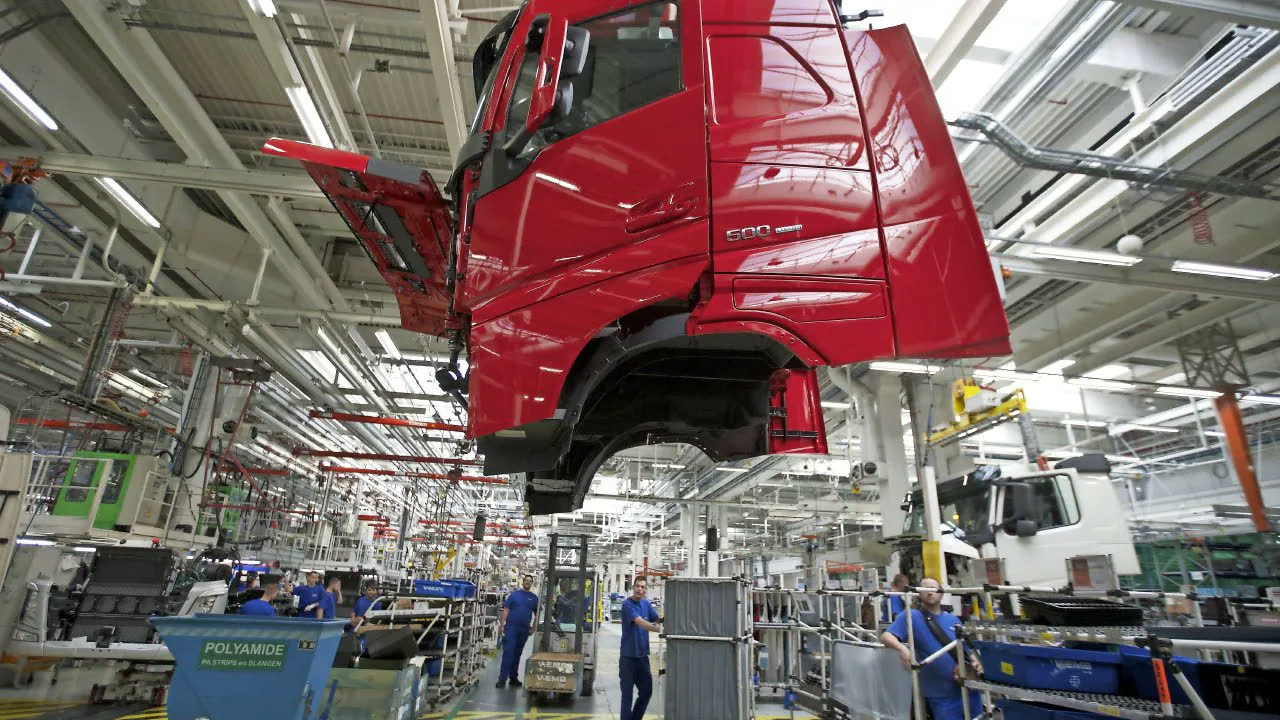 Red Volvo truck on the production line inside the factory.